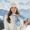 Model wearing SoieVia™ Frosted Ridge silk scarf in a snowy Alpine landscape — 18 mm silk twill in soft ivory and silver tones inspired by frost-covered mountain ridges, elegant winter luxury.